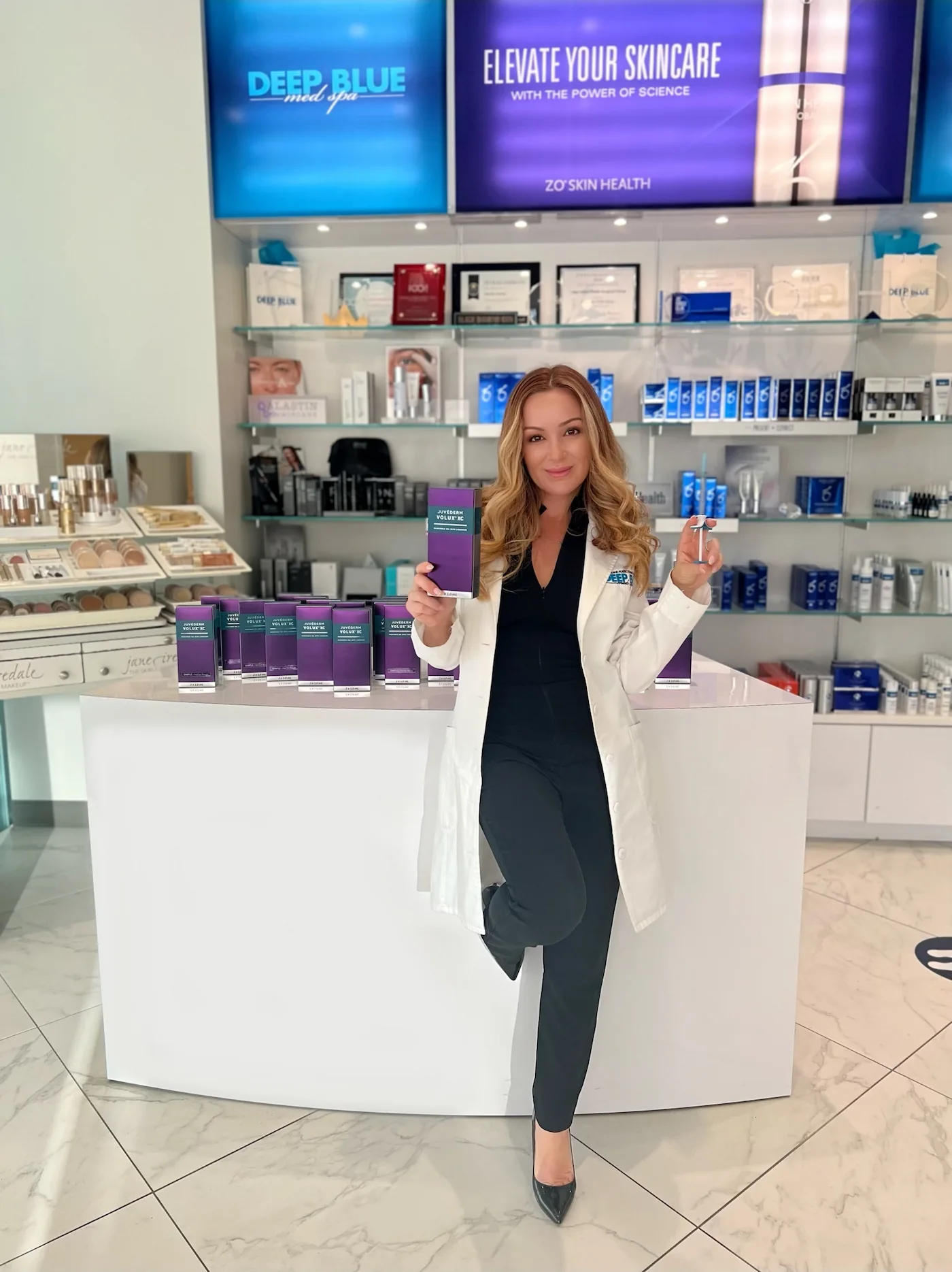 Lead PA Melissa Colletti-White posing with JUVÉDERM® VOLUX™ XC inside Deep Blue Med Spa